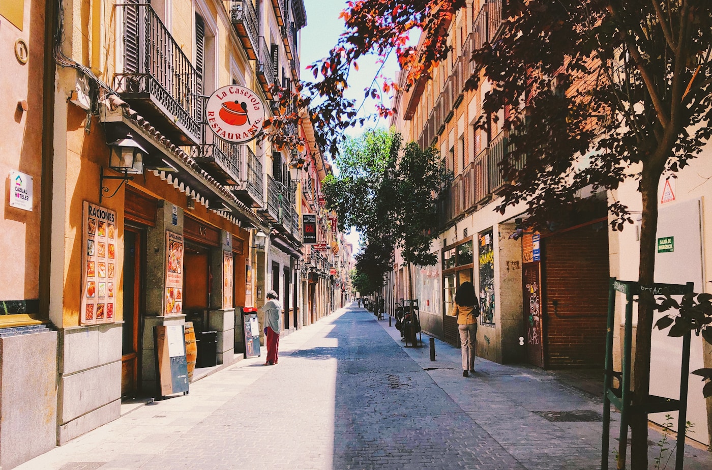Narrow Malasaña street with cafés and balconies